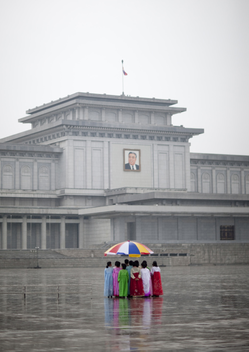 North Korean women under the rain in Kumsusan palace of the sun that serves as the mausoleum for Kim Il-sung and Kim Jong-il, Pyongan Province, Pyongyang, North Korea