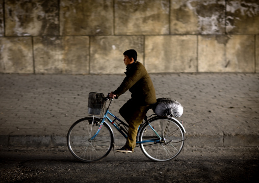 North Korean man riding a bicycle in a tunnel, Pyongan Province, Pyongyang, North Korea