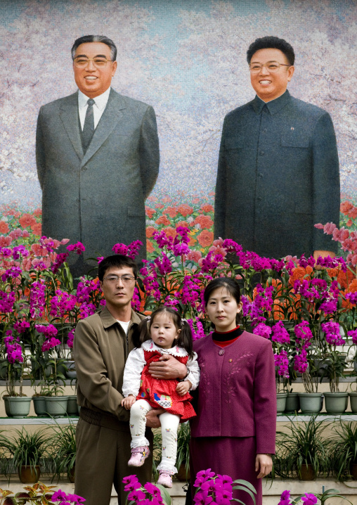 North Korean family posing in the international Kimilsungia and Kimjongilia festival, Pyongan Province, Pyongyang, North Korea