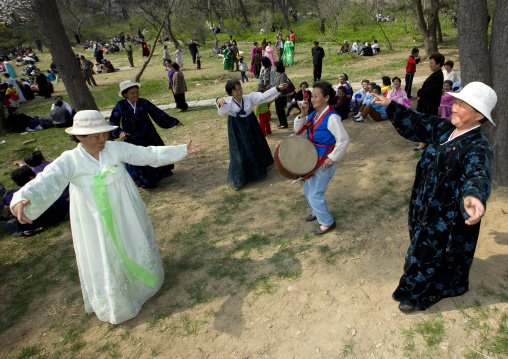 North Korean women dancing in a park for the day of the sun which is the birth anniversary of Kim Il-sung, Pyongan Province, Pyongyang, North Korea