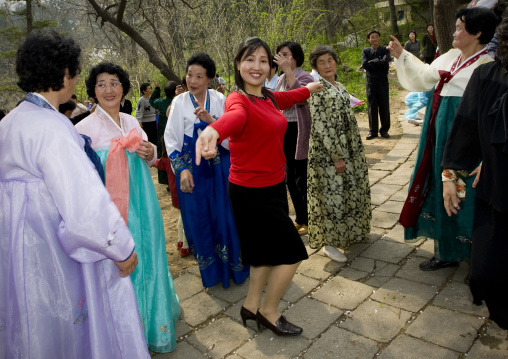 North Korean women dancing in a park for the day of the sun which is the birth anniversary of Kim Il-sung, Pyongan Province, Pyongyang, North Korea