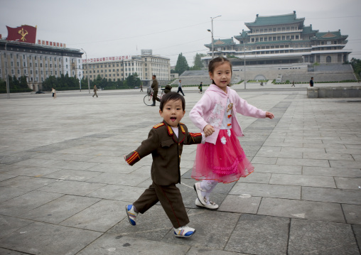 North Korean boy dressed in soldier with his sister in choson-ot on Kim il Sung square, Pyongan Province, Pyongyang, North Korea