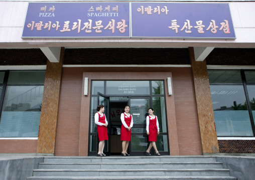 Pizzeria waitresses in front of an italian restaurant, Pyongan Province, Pyongyang, North Korea