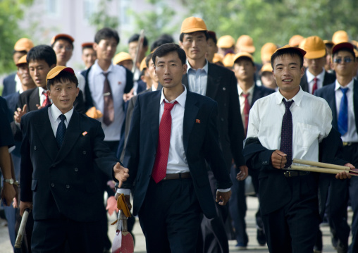 North Korean teenagers with yellow caps during the celebration of the 60th anniversary of the regim, Pyongan Province, Pyongyang, North Korea