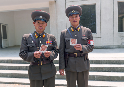 North Korean soldiers with polaroids in the joint security area of the Demilitarized Zone, North Hwanghae Province, Panmunjom, North Korea