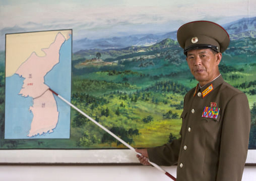 North Korean soldier in the joint security area in front of the map of Korea, North Hwanghae Province, Panmunjom, North Korea