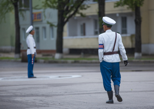 North Korean male traffic security officers in white uniforms in the street, North Hwanghae Province, Kaesong, North Korea
