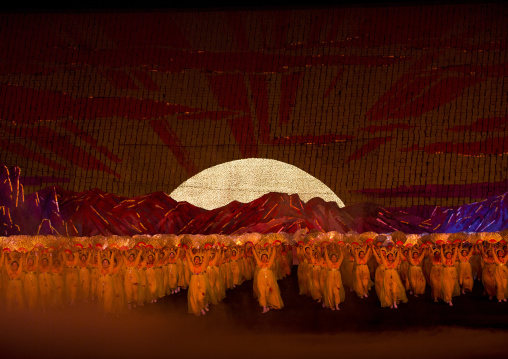Rising sun over mount Paektu made by children pixels holding up colored boards during Arirang mass games in may day stadium, Pyongan Province, Pyongyang, North Korea