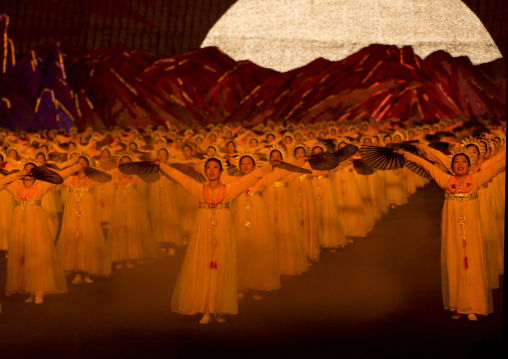 North Korean dancers in front of rising sun over mount Paektu made by children holding up boards during Arirang mass games in may day stadium, Pyongan Province, Pyongyang, North Korea