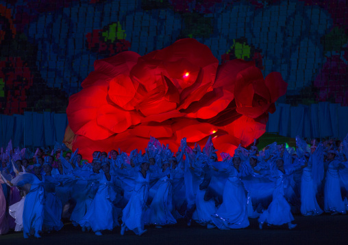 North Korean women dancing in front of a giant Kimilsungia flower during the Arirang mass games in may day stadium, Pyongan Province, Pyongyang, North Korea
