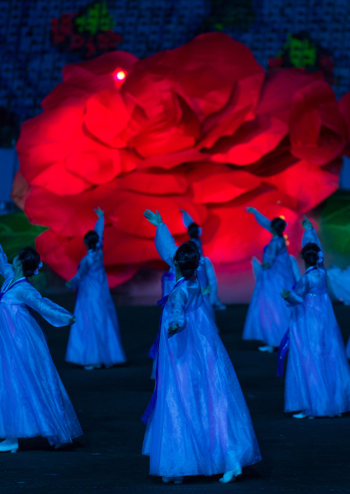 North Korean women dancing in choson-ot in front of a giant Kimilsungia fower during the Arirang mass games in may day stadium, Pyongan Province, Pyongyang, North Korea