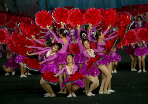 North Korean gymnasts holiding red flowers during Arirang mass games in may day stadium, Pyongan Province, Pyongyang, North Korea