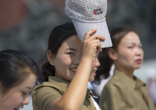 Smiling North Korean woman with a cap in the street, Pyongan Province, Pyongyang, North Korea