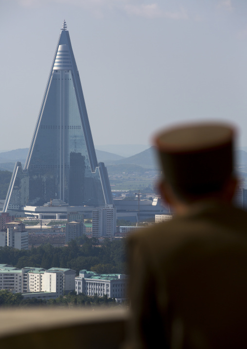 North Korean soldier watching Ryugyong hotel from the Juche tower, Pyongan Province, Pyongyang, North Korea