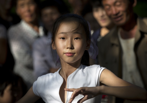 North Korean girl dancing in a park on september 9 day of the foundation of the republic, Pyongan Province, Pyongyang, North Korea