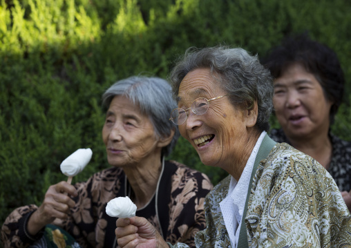 North Korean women eating ice creams in a park on september 9 day of the foundation of the republic, Pyongan Province, Pyongyang, North Korea