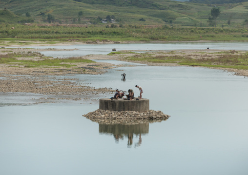 North Korean men having a bath in a river, South Hamgyong Province, Hamhung, North Korea