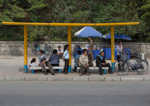 North Korean people waiting for a bus in the street, South Hamgyong Province, Hamhung, North Korea