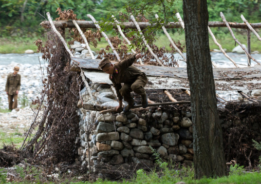 North Korean soldiers in a shelter made of stones along a river, Pyongan Province, Pyongyang, North Korea