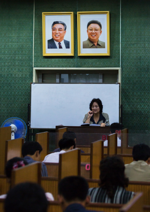 North Korean students during an english classroom in the Grand people's study house under the official portraits of the Dear Leaders, Pyongan Province, Pyongyang, North Korea