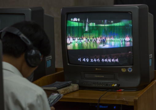 North Korean man watching a video tape in the multimedia room of the Grand people's study house, Pyongan Province, Pyongyang, North Korea