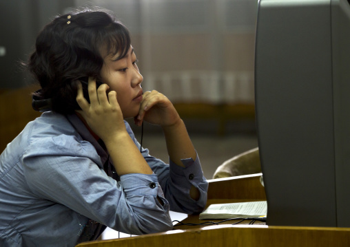North Korean woman watching a dvd at the Grand people's study house, Pyongan Province, Pyongyang, North Korea