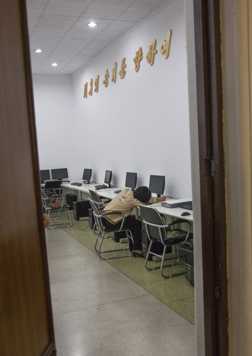 North Korean student sleeping in the computers room at the Grand people's study house, Pyongan Province, Pyongyang, North Korea