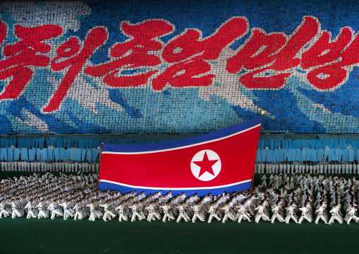 North Korean taekwondo team in front of a giant flag during the Arirang mass games in may day stadium, Pyongan Province, Pyongyang, North Korea