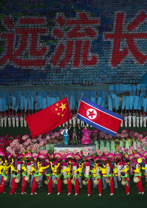 North Korean and chinese flags during the Arirang mass games in may day stadium, Pyongan Province, Pyongyang, North Korea