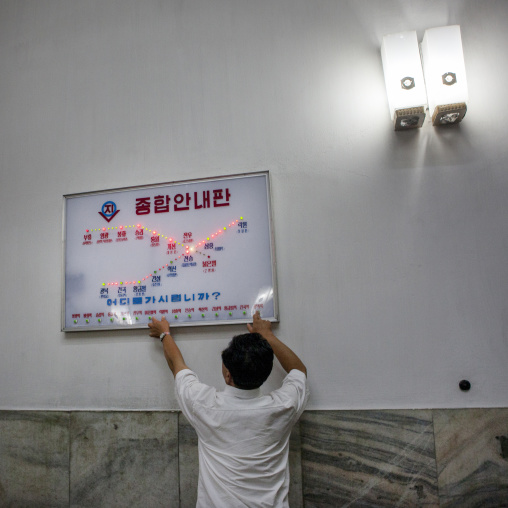 North Korean man testing the electronic board of the metro lines, Pyongan Province, Pyongyang, North Korea