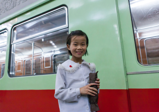 Smiling North Korean child girl in the subway, Pyongan Province, Pyongyang, North Korea
