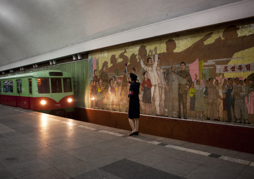 Subway leaving the station in front of a North Korean control woman, Pyongan Province, Pyongyang, North Korea