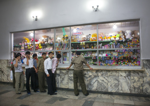 North Korean peiople in front of a dvd and gifts shop inside the subway, Pyongan Province, Pyongyang, North Korea