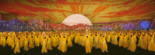 Rising sun over mount Paektu made by children pixels holding up colored boards during Arirang mass games in may day stadium, Pyongan Province, Pyongyang, North Korea