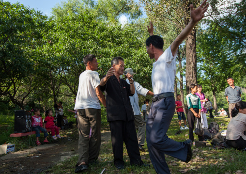 North Korean men singing in a park on national day, Pyongan Province, Pyongyang, North Korea