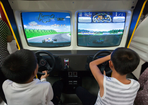 North Korean child on a car simulator in Kaeson youth park, Pyongan Province, Pyongyang, North Korea