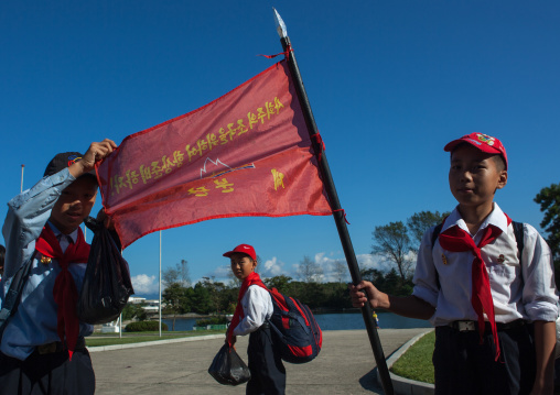 North Korean pioneers with their flag in Songdowon international children's camp and the slogan let us always prepare for our homeland of socialism!, Kangwon Province, Wonsan, North Korea