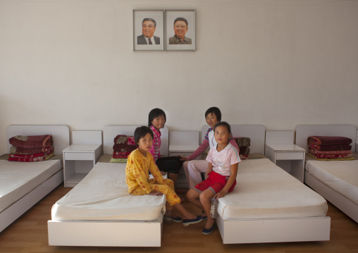 North Korean girls in a room under the official portraits of the Dear Leaders in Songdowon international children's camp, Kangwon Province, Wonsan, North Korea