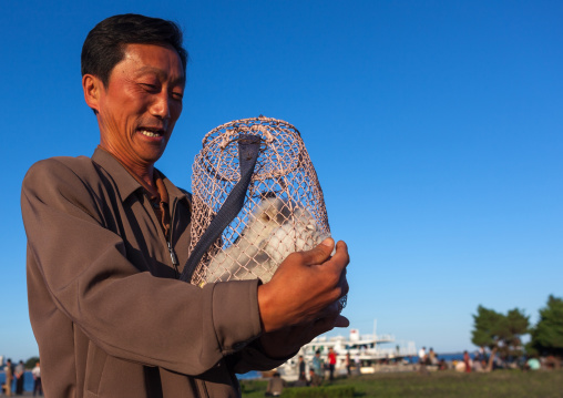 Portrait of a North Korean man buying a dog, Kangwon Province, Wonsan, North Korea