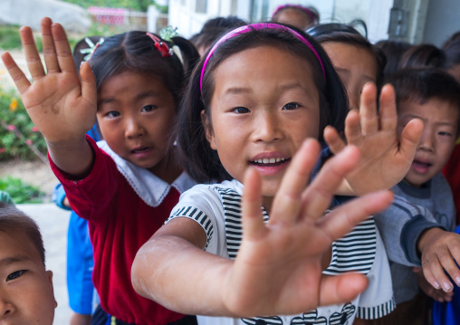 Group of North Korean children waving in a school, South Hamgyong Province, Hamhung, North Korea
