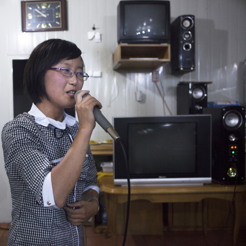 North Korean woman singing in a karaoke, Pyongan Province, Pyongyang, North Korea