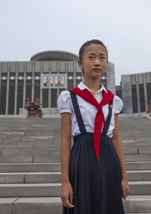 North Korean pioneer girl in front of Mangyongdae children's palace, Pyongan Province, Pyongyang, North Korea