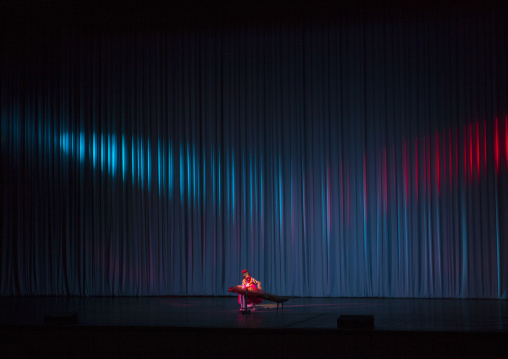 Young North Korean artist playing kayagum on stage in Mangyongdae children's palace, Pyongan Province, Pyongyang, North Korea