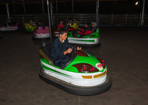North Korean people having fun in bumper cars at Kaeson youth park, Pyongan Province, Pyongyang, North Korea