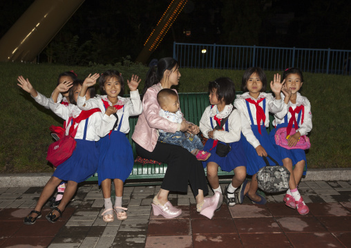 North Korean pioneers girls in a park at night, Pyongan Province, Pyongyang, North Korea