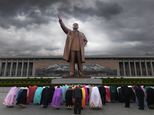North Korean people bowing in front of Kim il Sung statue in Mansudae Grand monument, Pyongan Province, Pyongyang, North Korea