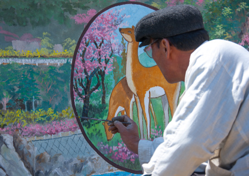 North Korean artist painting a propaganda wall in the countryside, North Hamgyong Province, Chilbo Sea, North Korea