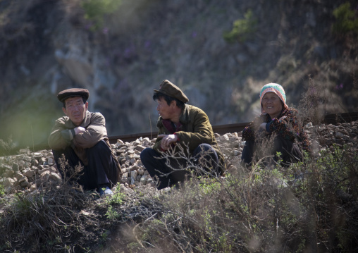 North Korean people squatting near a railway, North Hamgyong Province, Chilbo Sea, North Korea