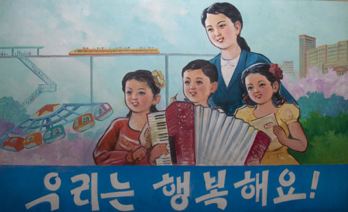 Propaganda poster in Tchang Gwang school depicting a North Korean family saying they are happy, North Hamgyong Province, Chongjin, North Korea