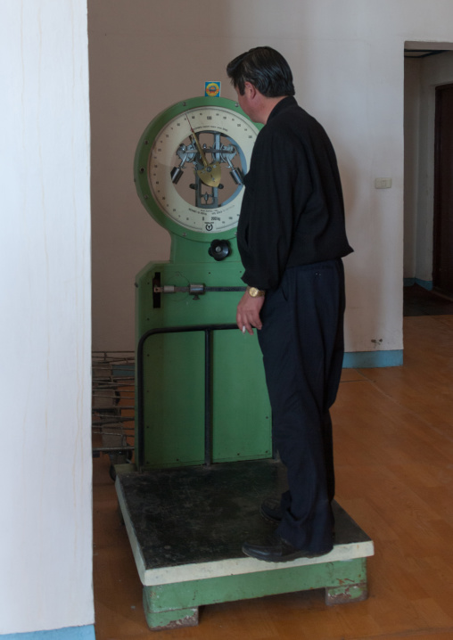 North Korean man using a weighing machine in an airport
, North Hamgyong Province, Pyongyang, North Korea